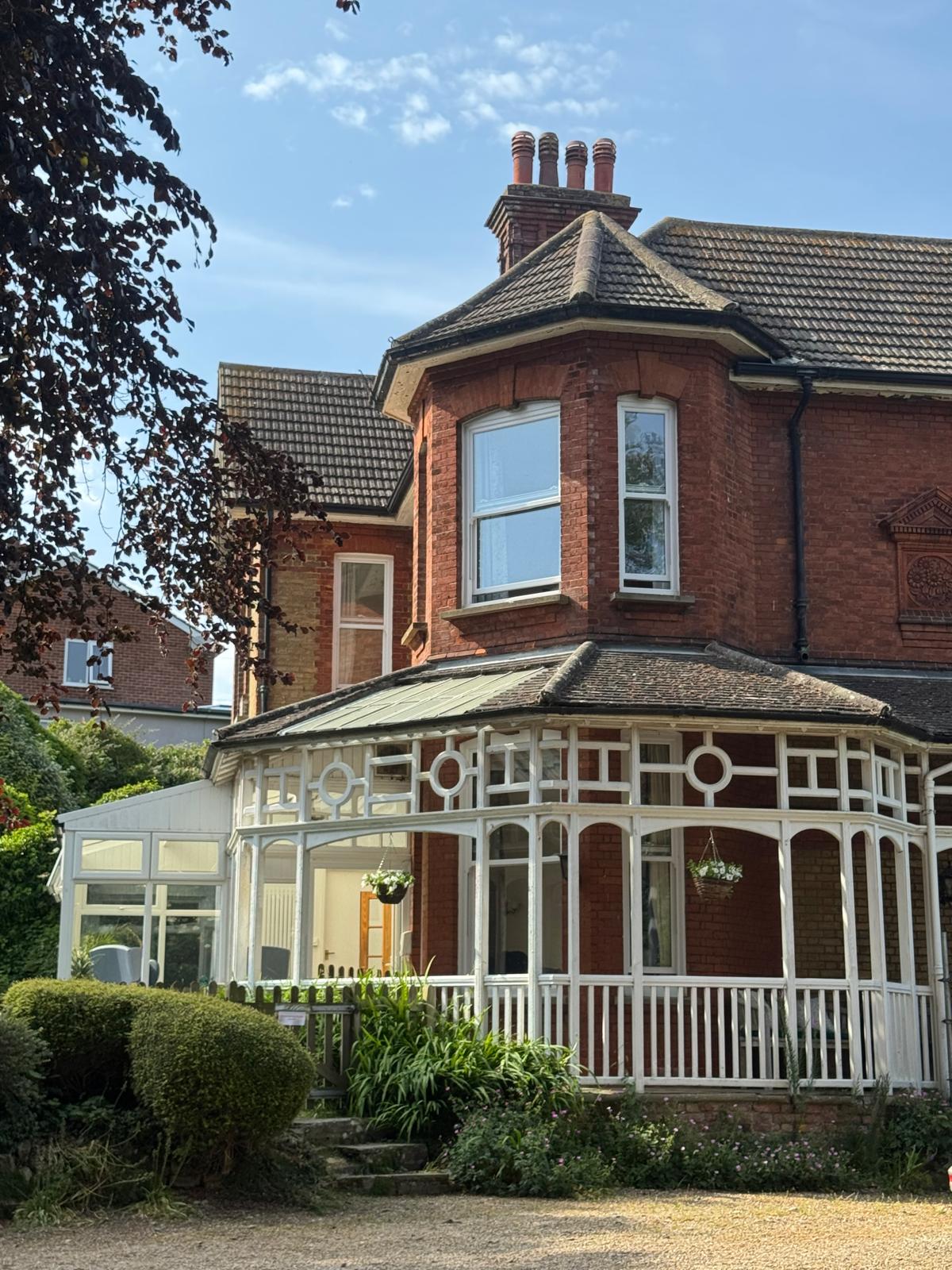 St Anselm's red-brick Victorian house with its white-framed conservatory and garden in Walmer